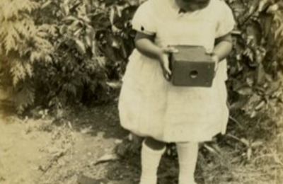 A little girl holding a camera